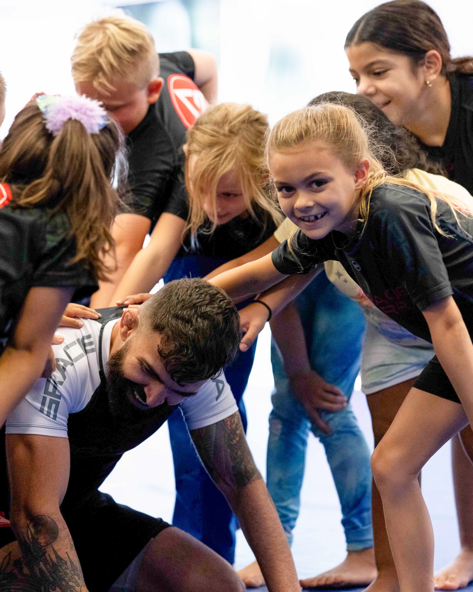 Kids training Brazilian Jiu-Jitsu with instructor at Gracie Barra Whittier